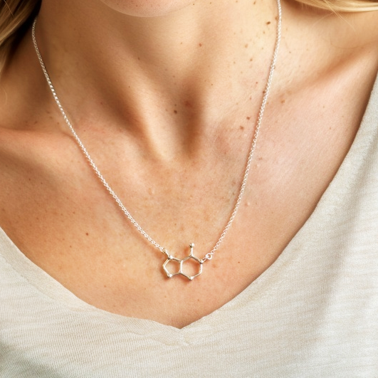 Silver adenine molecule necklace worn on the neck, highlighting the sleek design and scientific structure. Silver adenine molecule necklace worn on the neck, highlighting the sleek design and scientific structure.