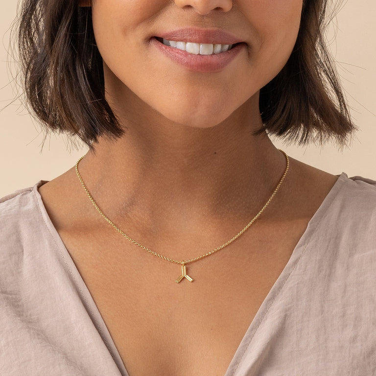 Gold vermeil antibody necklace on model, a perfect gift for scientists and health professionals. Gold vermeil antibody necklace on model, a perfect gift for scientists and health professionals.