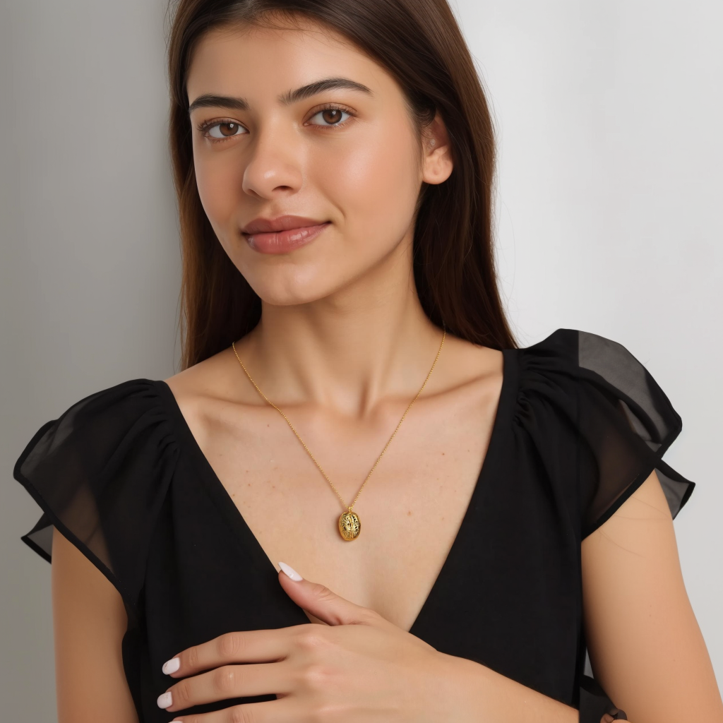 A young woman with long, dark hair wearing a black V-neck top and a gold vermeil brain necklace. She gently touches the pendant while looking at the camera with a soft smile. A young woman with long, dark hair wearing a black V-neck top and a gold vermeil brain necklace. She gently touches the pendant while looking at the camera with a soft smile.