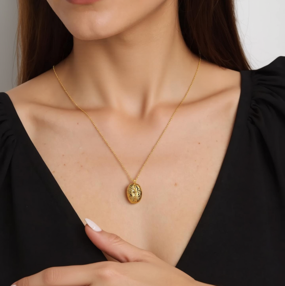 A close-up shot of a woman’s neck and collarbone area, highlighting the gold vermeil brain necklace resting just below her collarbone. The fine chain and intricate pendant details are clearly visible. A close-up shot of a woman’s neck and collarbone area, highlighting the gold vermeil brain necklace resting just below her collarbone. The fine chain and intricate pendant details are clearly visible.