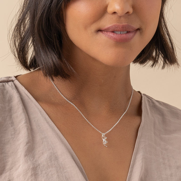 Sterling silver DNA necklace with a minimalist design, ideal for science enthusiasts. Sterling silver DNA necklace with a minimalist design, ideal for science enthusiasts.