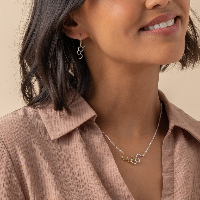 Stylish woman showing off her dopamine-serotonin necklace. Stylish woman showing off her dopamine-serotonin necklace.