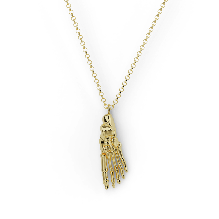 Gold vermeil foot anatomy necklace featuring a detailed skeletal structure of the foot, set against a white background. Gold vermeil foot anatomy necklace featuring a detailed skeletal structure of the foot, set against a white background.