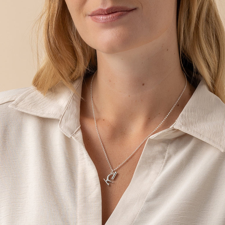 Model wearing sterling silver microscope necklace, showcasing its elegant design. Model wearing sterling silver microscope necklace, showcasing its elegant design.