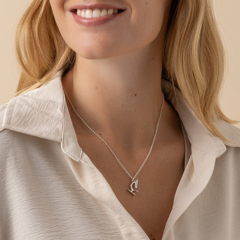 Microscope necklace worn as a statement piece for microbiologists and historians. Microscope necklace worn as a statement piece for microbiologists and historians.