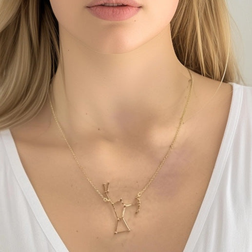 Close-up of a woman’s neck wearing the gold vermeil Orion constellation necklace, showing the pendant’s elegant alignment of stars. Close-up of a woman’s neck wearing the gold vermeil Orion constellation necklace, showing the pendant’s elegant alignment of stars.