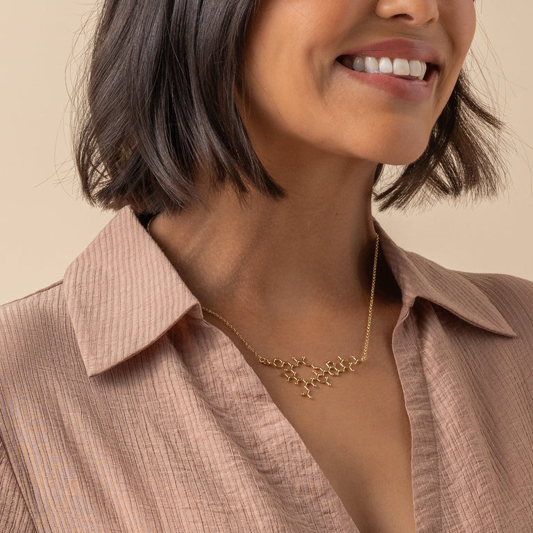 Close-up of the Oxytocin Necklace against a neutral background, emphasizing its scientific elegance Close-up of the Oxytocin Necklace against a neutral background, emphasizing its scientific elegance