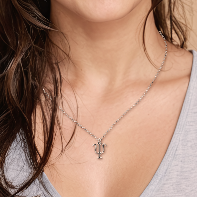 A close-up shot of a woman wearing the psi necklace, showcasing its delicate and scientific-inspired design. A close-up shot of a woman wearing the psi necklace, showcasing its delicate and scientific-inspired design.