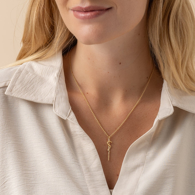 Rod of Asclepius pendant necklace in gold vermeil, hanging on a delicate chain, perfect for doctors and medical students. Rod of Asclepius pendant necklace in gold vermeil, hanging on a delicate chain, perfect for doctors and medical students.