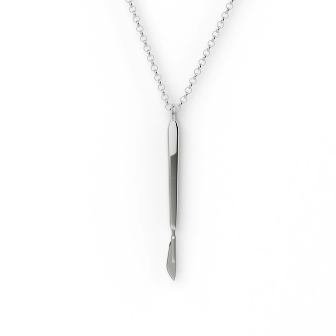 Sterling silver scalpel necklace displayed on a model, showcasing fine detail. Sterling silver scalpel necklace displayed on a model, showcasing fine detail.