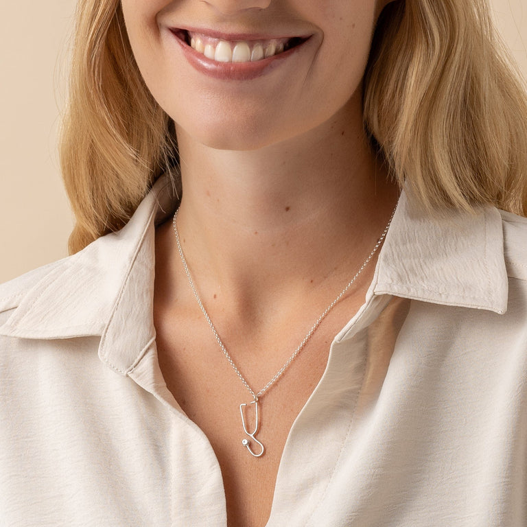 Healthcare-inspired Stethoscope Necklace on model, perfect for med students and professionals. Healthcare-inspired Stethoscope Necklace on model, perfect for med students and professionals.