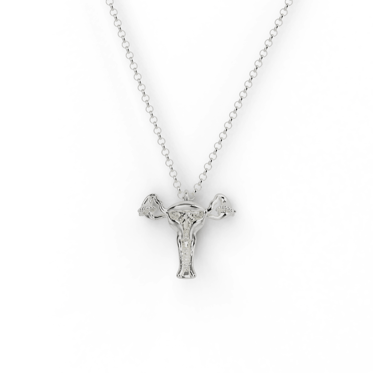 Sterling silver uterus necklace featuring a detailed anatomical design, hanging on a delicate chain. A perfect science-inspired jewelry piece. Sterling silver uterus necklace featuring a detailed anatomical design, hanging on a delicate chain. A perfect science-inspired jewelry piece.