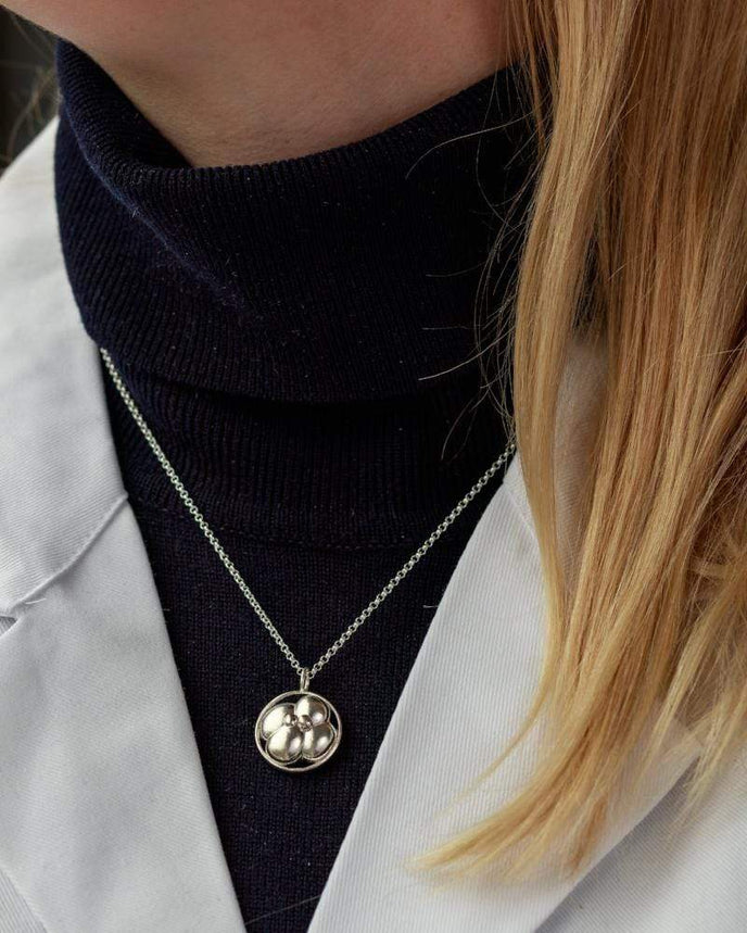 Close-up of a model wearing a 4-cell embryo necklace, symbolizing life’s early stages in elegant silver. Close-up of a model wearing a 4-cell embryo necklace, symbolizing life’s early stages in elegant silver.