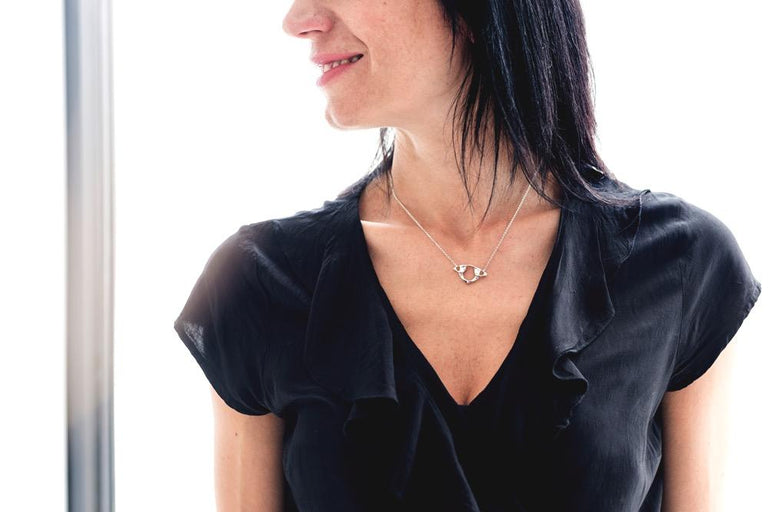 Side view of the Atlas Necklace, highlighting its anatomical design and silver craftsmanship Side view of the Atlas Necklace, highlighting its anatomical design and silver craftsmanship