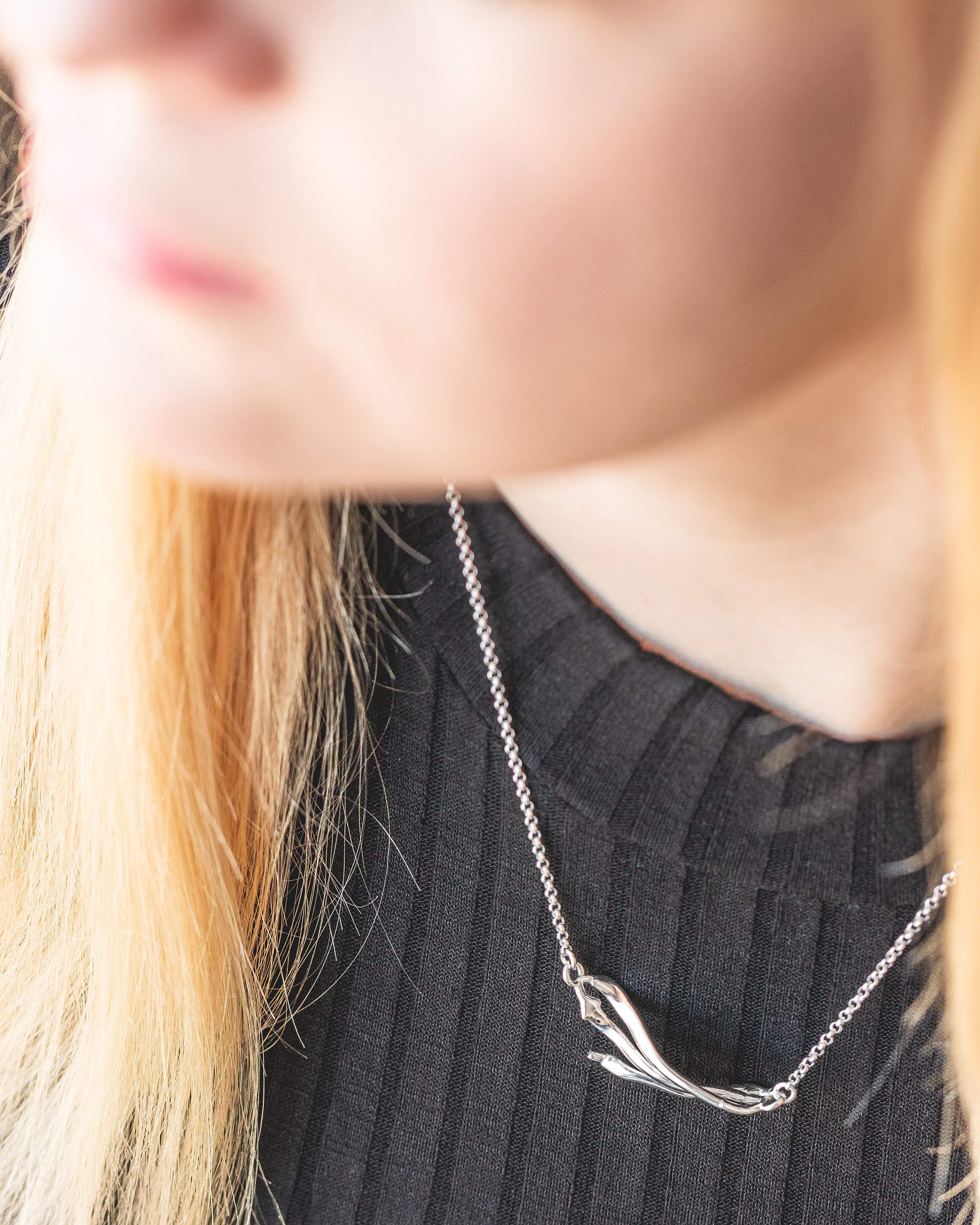 Model wearing the beta sheet necklace in silver. A minimalist science jewelry piece designed for protein lovers and researchers. Model wearing the beta sheet necklace in silver. A minimalist science jewelry piece designed for protein lovers and researchers.