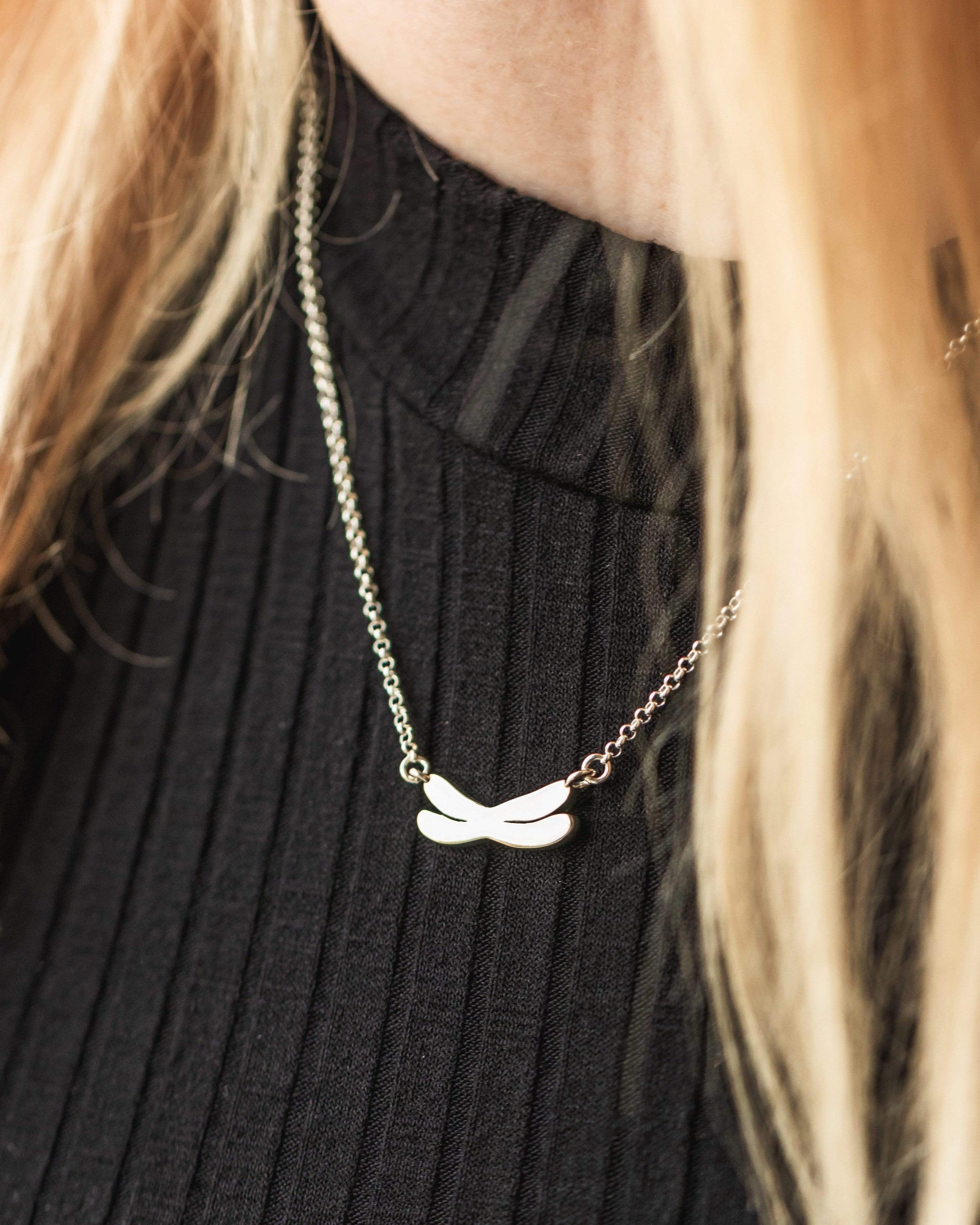 Close-up of the chromosome necklace, showcasing sleek 3D-printed silver craftsmanship. Close-up of the chromosome necklace, showcasing sleek 3D-printed silver craftsmanship.