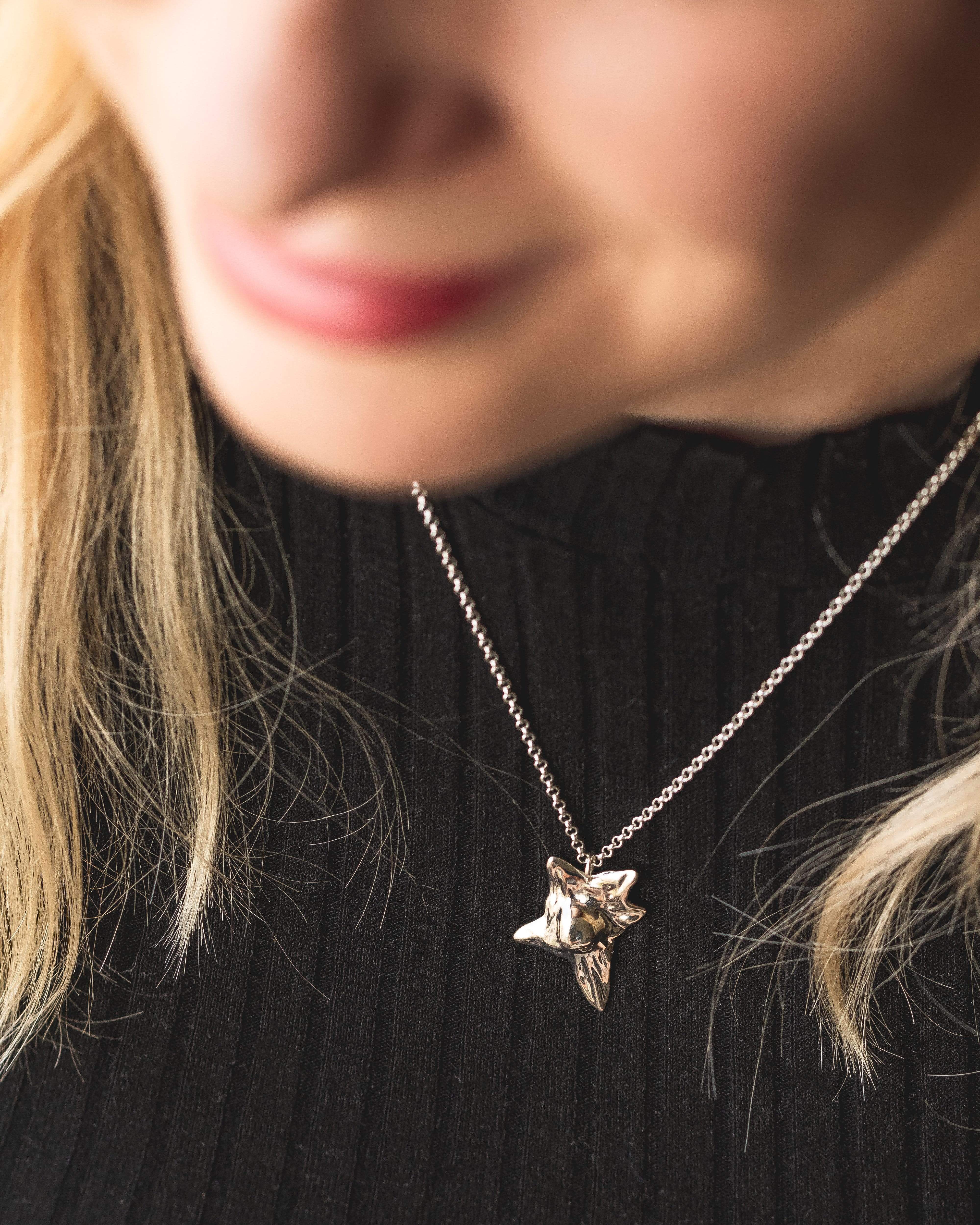 Close-up of a silver fibroblast necklace, showcasing intricate cellular design inspired by science. Perfect for scientists and biology enthusiasts. Close-up of a silver fibroblast necklace, showcasing intricate cellular design inspired by science. Perfect for scientists and biology enthusiasts.