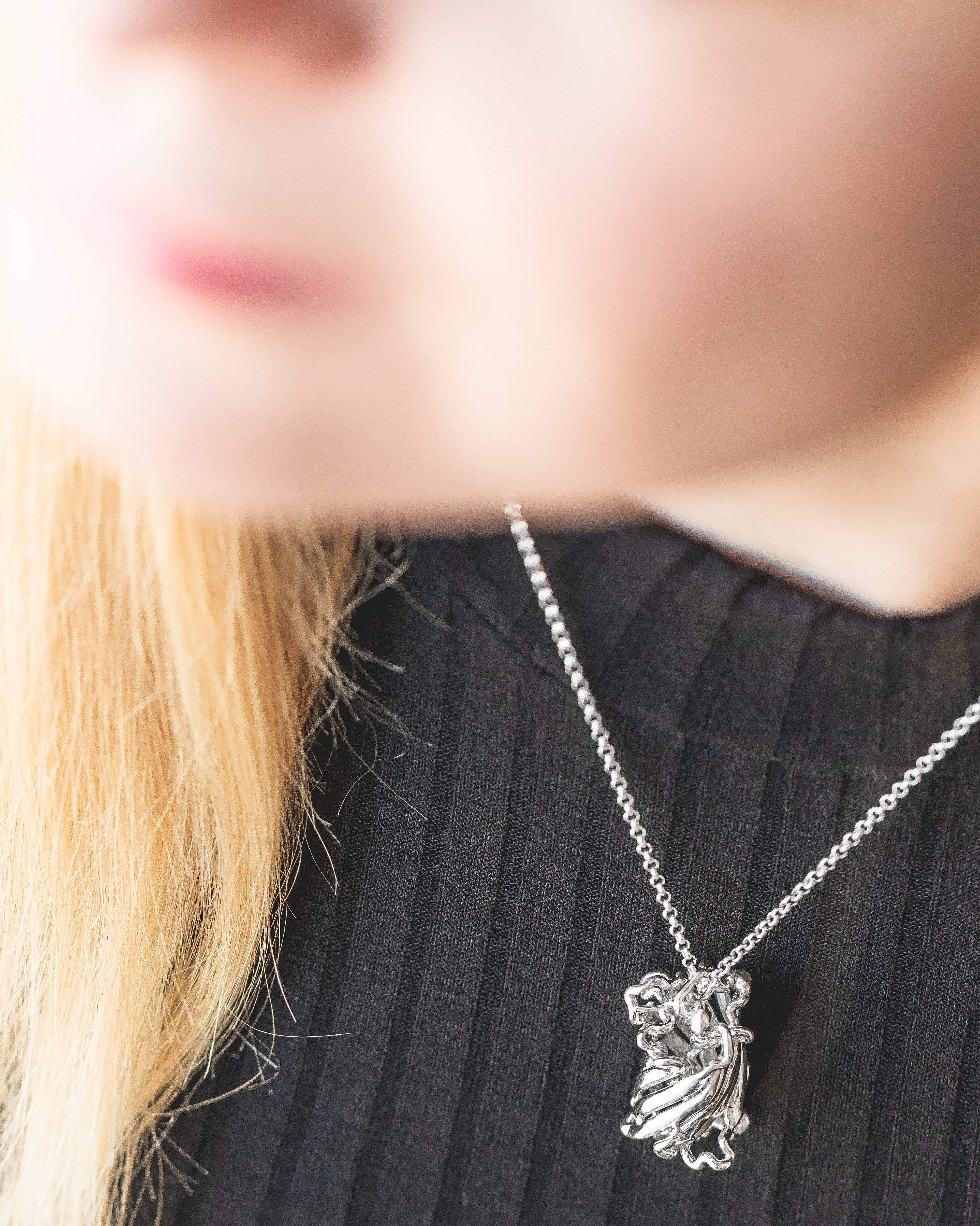 A model wearing the GFP necklace, showcasing its elegant science-inspired design. A model wearing the GFP necklace, showcasing its elegant science-inspired design.