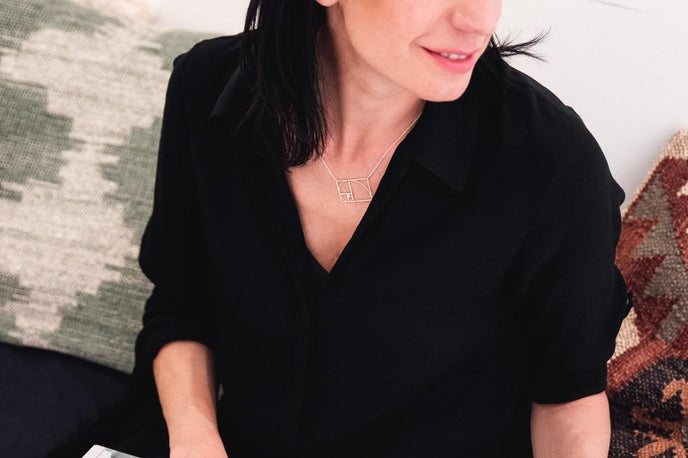 Elegant Golden Ratio Necklace in silver, worn by model showcasing timeless mathematical beauty. Elegant Golden Ratio Necklace in silver, worn by model showcasing timeless mathematical beauty.