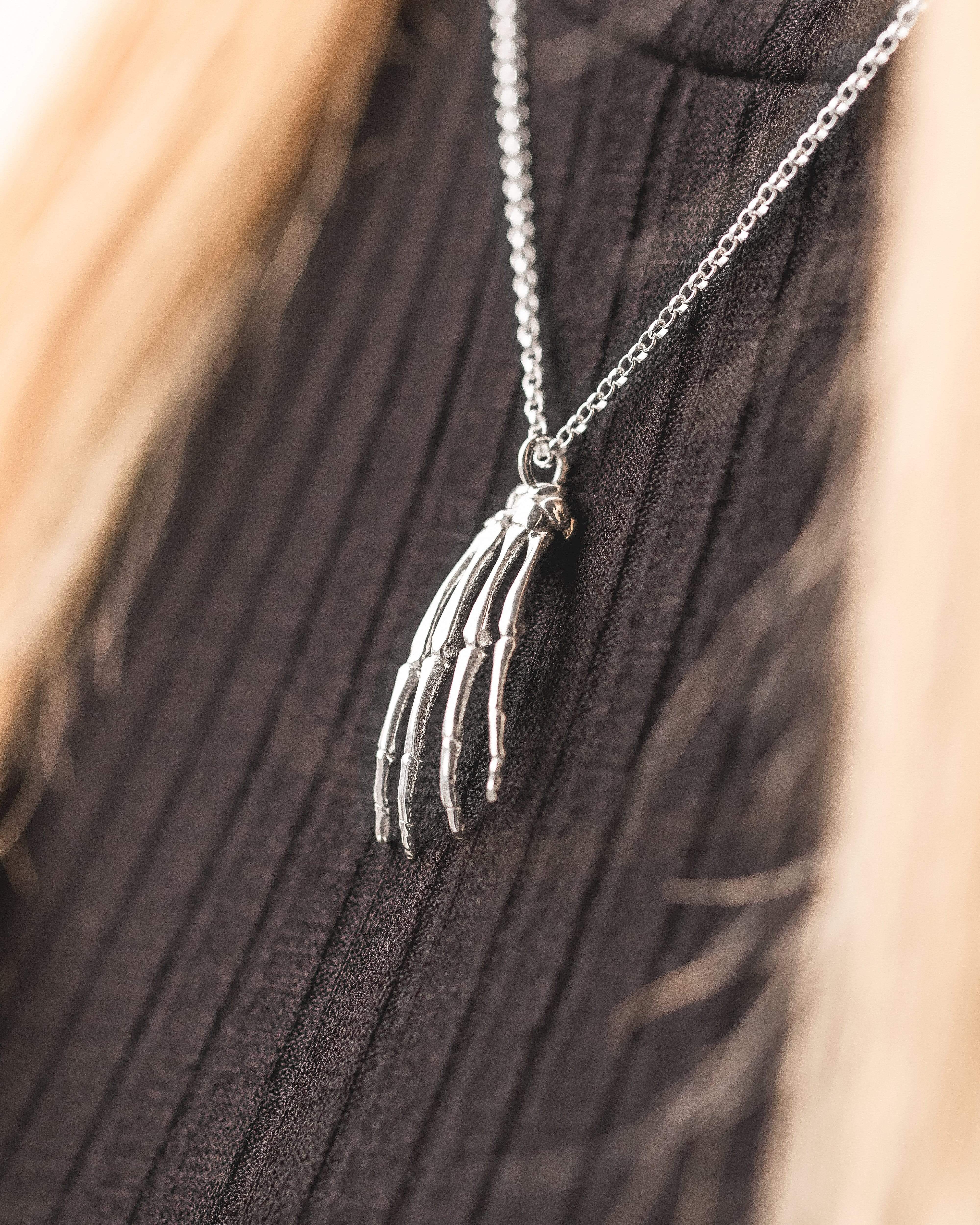 Model wearing the hand anatomy necklace, showcasing its elegant and detailed design. Model wearing the hand anatomy necklace, showcasing its elegant and detailed design.