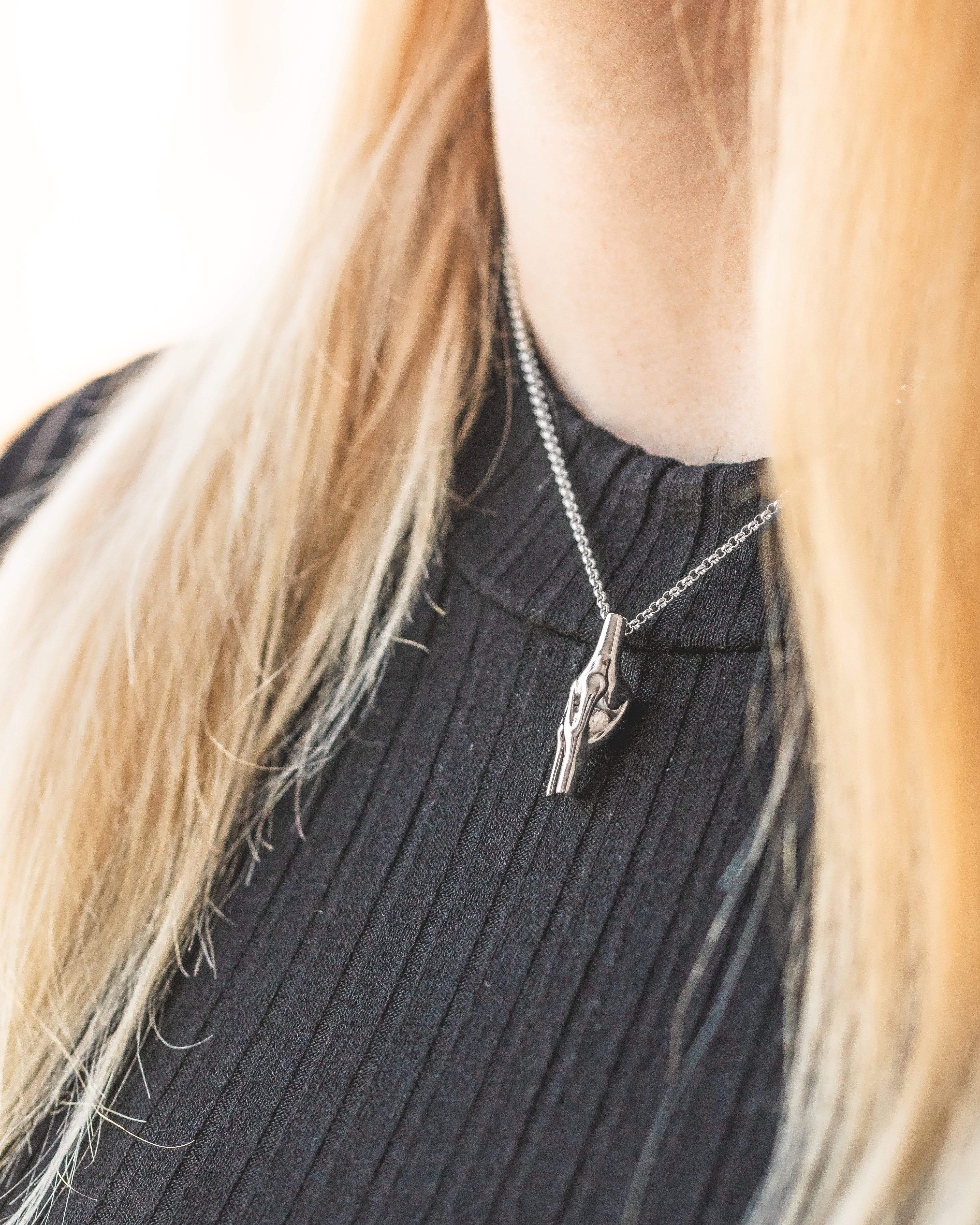 Close-up of a science-inspired knee necklace worn elegantly, highlighting intricate anatomical details. Close-up of a science-inspired knee necklace worn elegantly, highlighting intricate anatomical details.