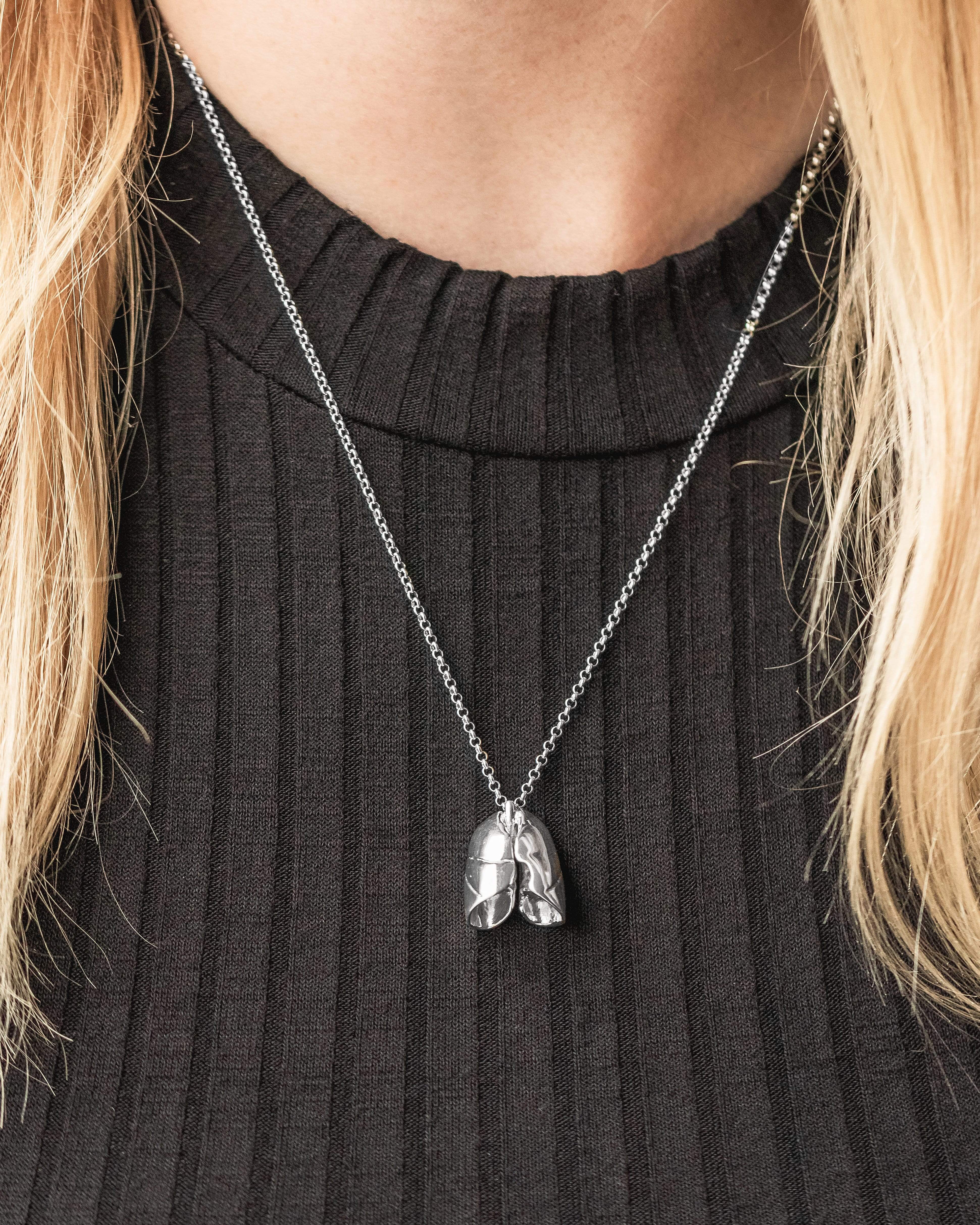 Lungs necklace worn around the neck, showcasing its intricate 3D design. Lungs necklace worn around the neck, showcasing its intricate 3D design.