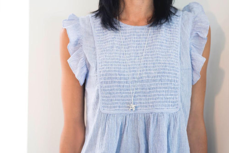 Model wearing a silver macrophage necklace, showcasing its elegant design and perfect size for everyday wear. Model wearing a silver macrophage necklace, showcasing its elegant design and perfect size for everyday wear.