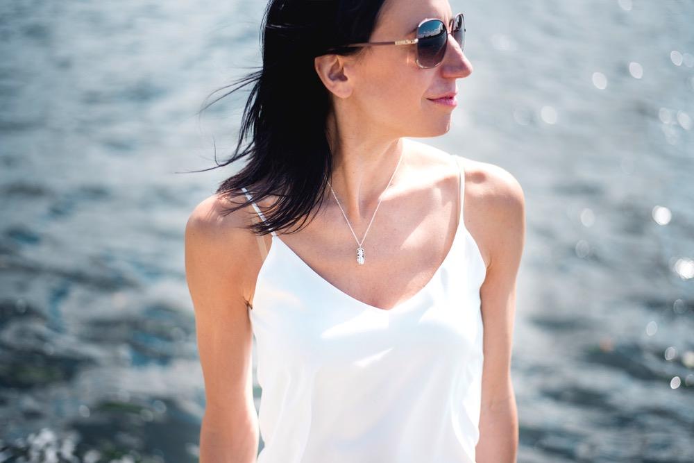 Model wearing a silver mitochondrion necklace, combining science elegance and style Model wearing a silver mitochondrion necklace, combining science elegance and style