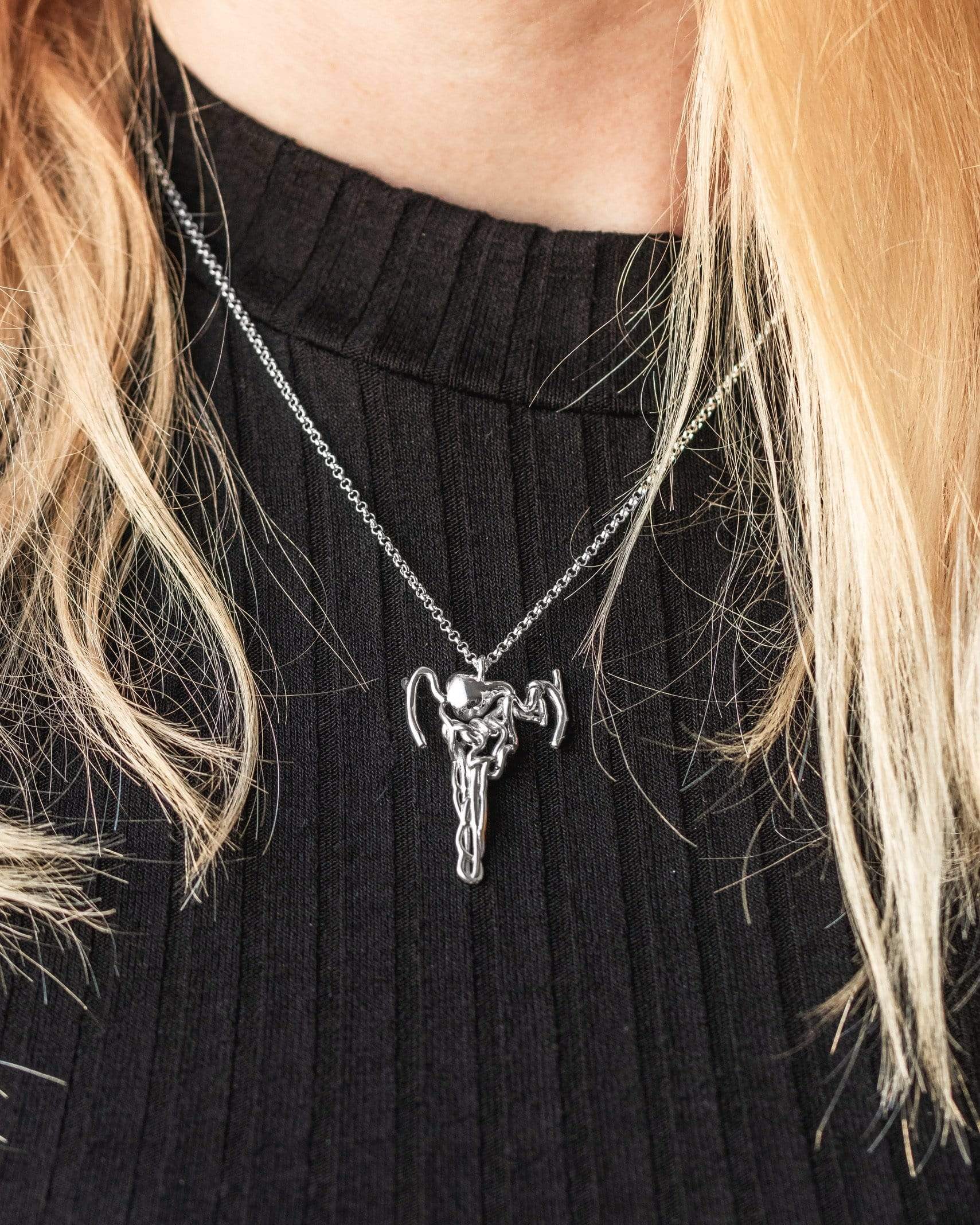 Model wearing the nephron necklace, a science-inspired piece celebrating kidney function with a sleek and stylish look. Model wearing the nephron necklace, a science-inspired piece celebrating kidney function with a sleek and stylish look.