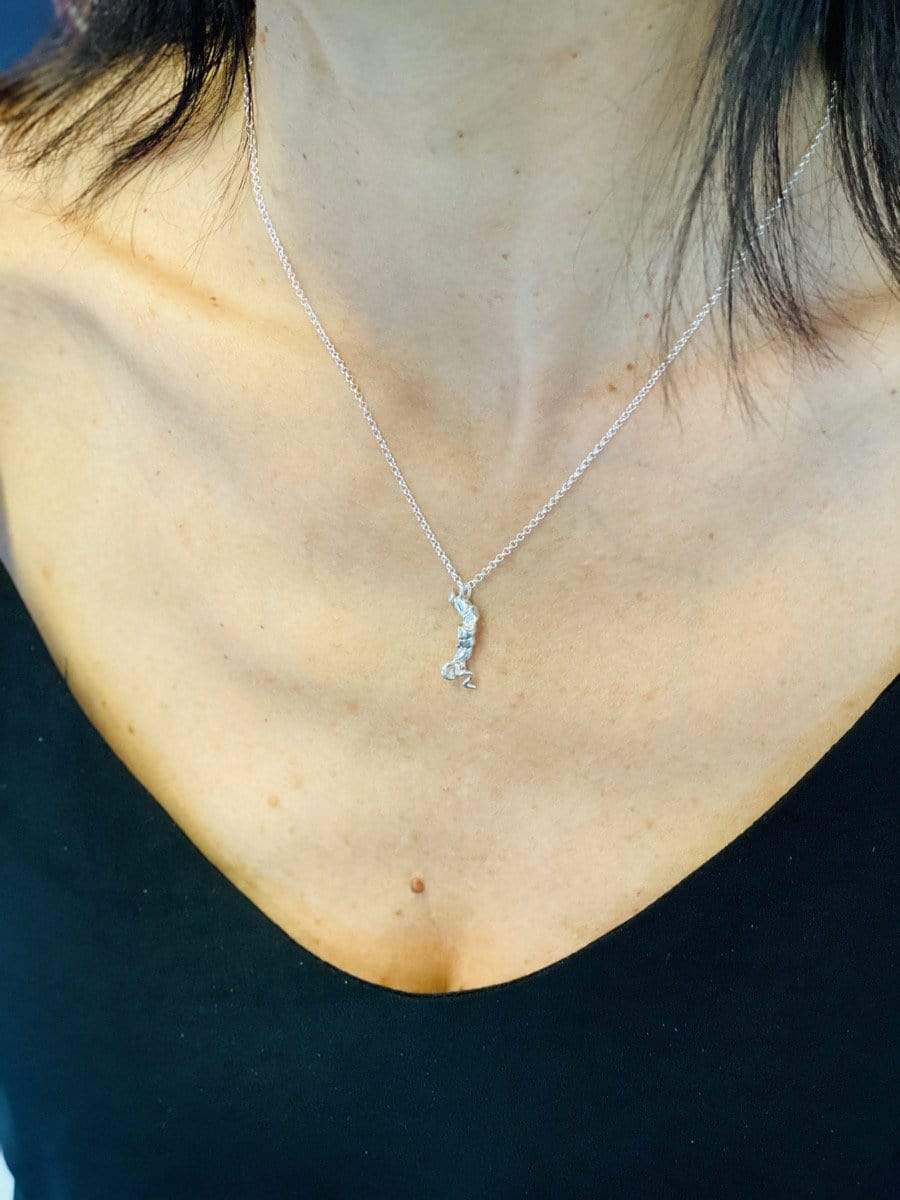 Person wearing the orexin necklace, showcasing its elegant design and science-inspired charm. Person wearing the orexin necklace, showcasing its elegant design and science-inspired charm.