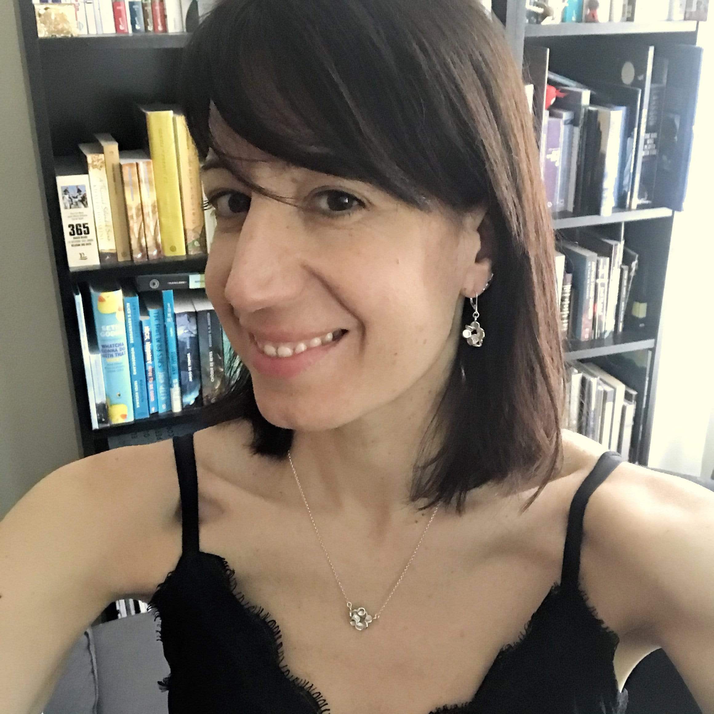 Woman Wearing Red Blood Cells Necklace – A stylish, silver red blood cells necklace, perfect for medical professionals and science enthusiasts. Woman Wearing Red Blood Cells Necklace – A stylish, silver red blood cells necklace, perfect for medical professionals and science enthusiasts.