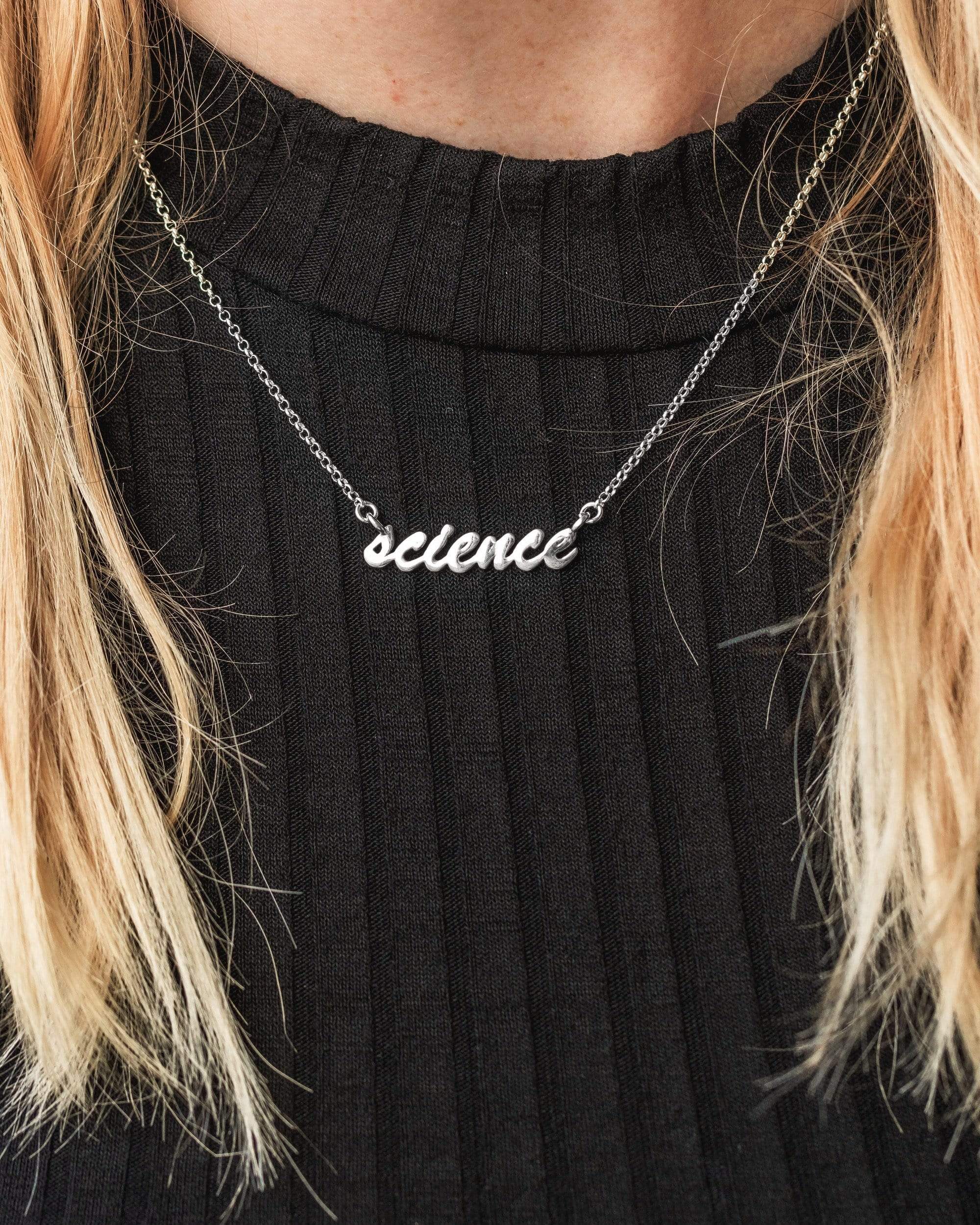 Model wearing the science necklace, a fashionable accessory for science lovers. Model wearing the science necklace, a fashionable accessory for science lovers.