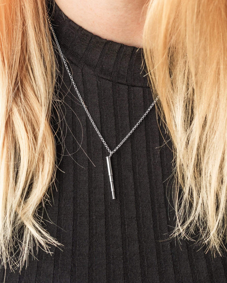 Close-up of a stylish telescope necklace worn around the neck, showcasing its elegant science-inspired design. Close-up of a stylish telescope necklace worn around the neck, showcasing its elegant science-inspired design.