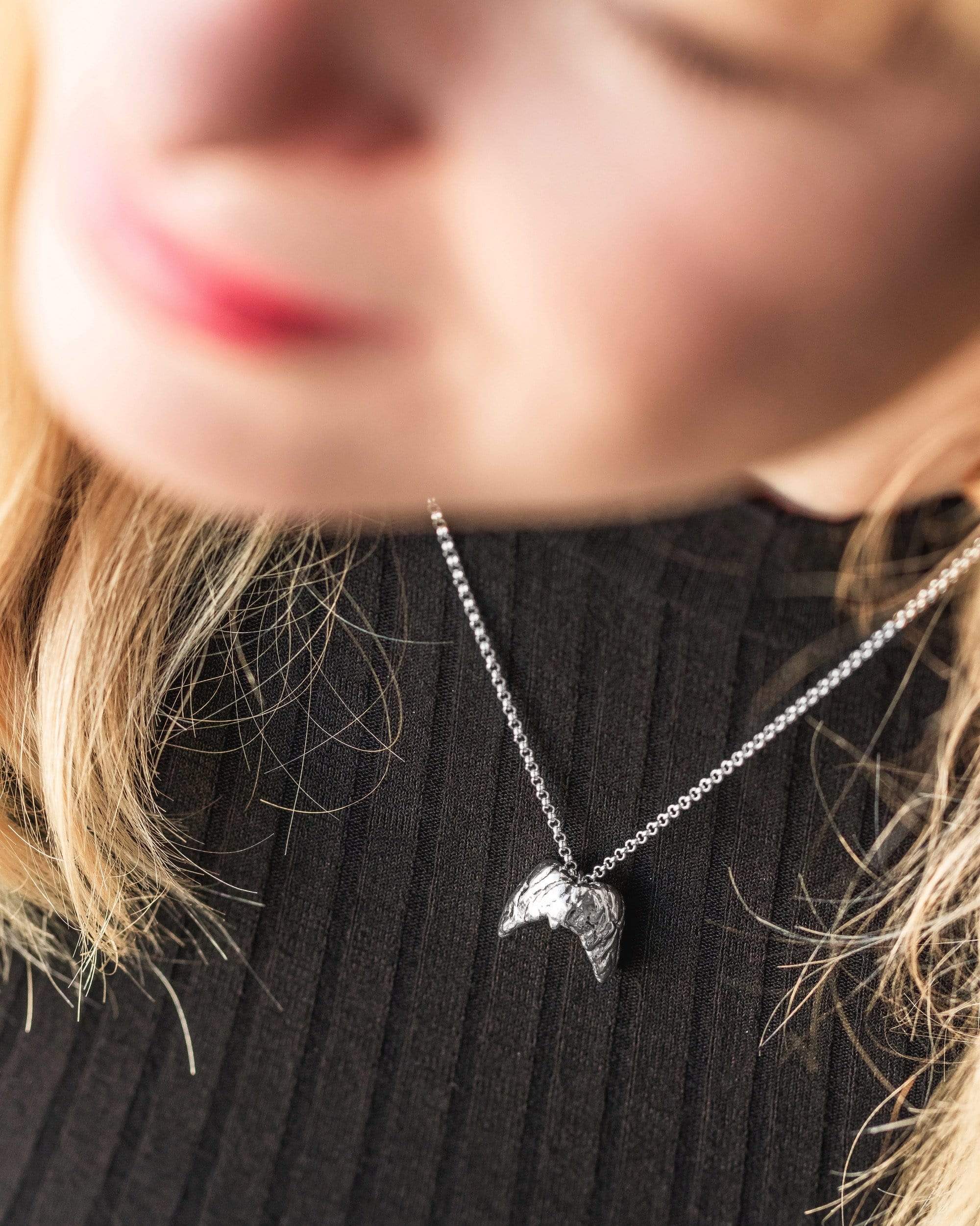 Close-up of a sterling silver thyroid necklace with a butterfly-inspired design, symbolizing the thyroid gland. Ideal for hypo/hyperthyroidism awareness. Close-up of a sterling silver thyroid necklace with a butterfly-inspired design, symbolizing the thyroid gland. Ideal for hypo/hyperthyroidism awareness.