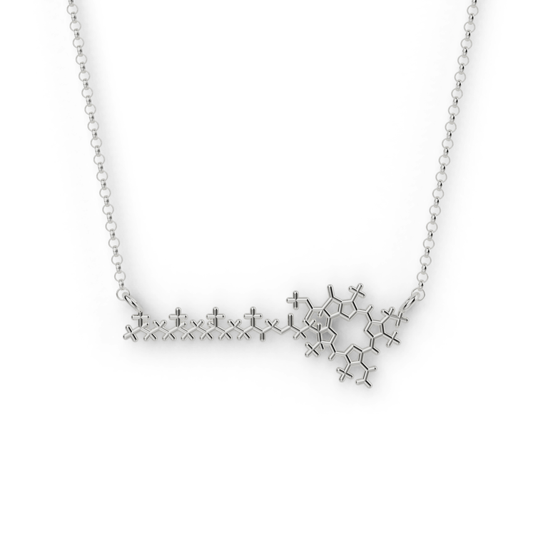 Close-up of a silver chlorophyll molecule necklace, a science-inspired jewelry piece for plant lovers and scientists.