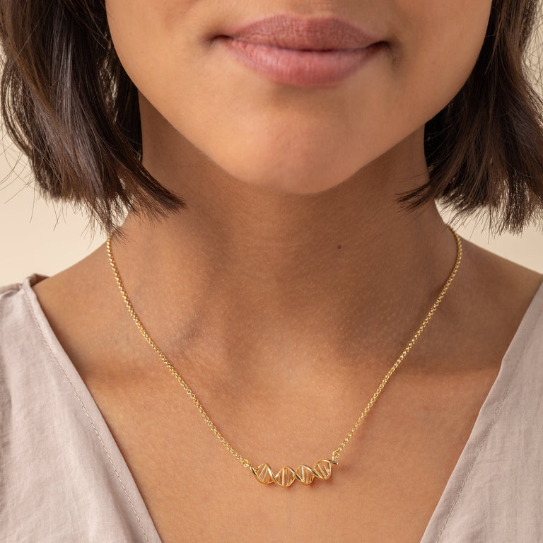 Elegant 18K gold vermeil DNA necklace on model, blending science and style.