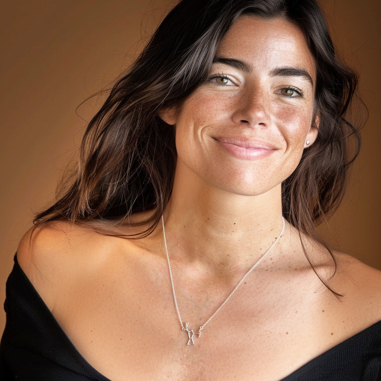 Smiling woman wearing the Orion constellation necklace, a modern astronomy-inspired jewelry piece symbolizing cosmic navigation and star alignment.