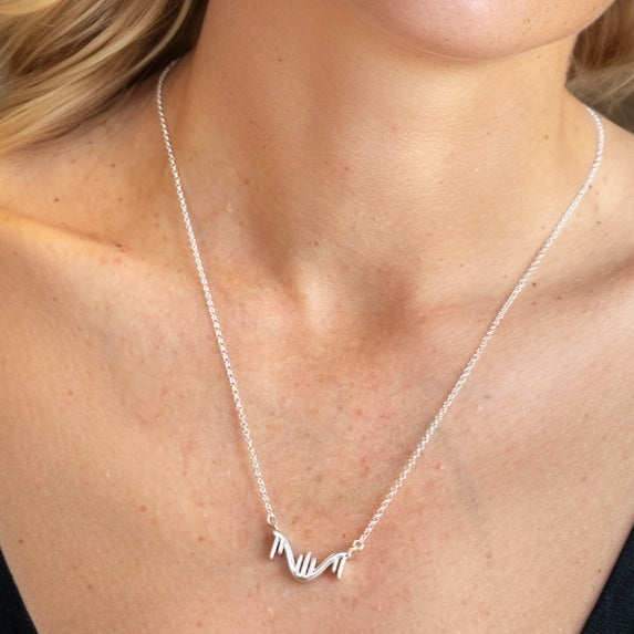 Minimalist RNA necklace in silver worn around the neck – molecular biology jewelry gift