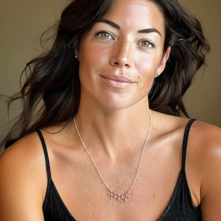 Woman wearing anthocyanin necklace in silver — elegant science jewelry symbolizing vibrant natural pigments and antioxidant molecules.