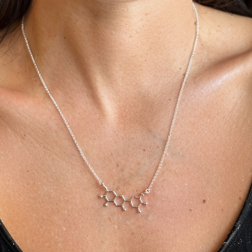 Anthocyanin molecule necklace worn close to the collarbone, minimalist science-inspired jewelry for biologists and chemistry lovers.