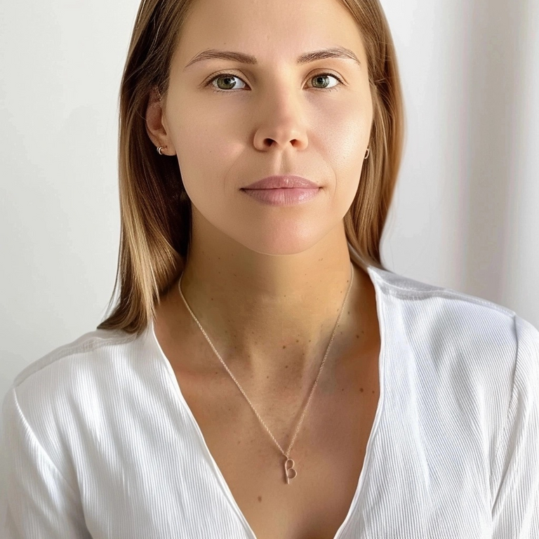 Woman with long brown hair wearing the beta necklace