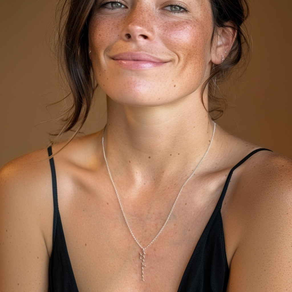 Woman wearing capsaicin molecule necklace in sterling silver – stylish science jewelry for spicy food lovers and bold style enthusiasts.