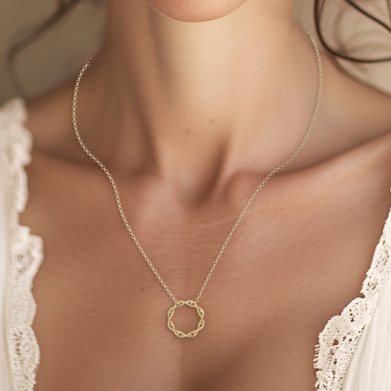 Close up view of a woman wearing a circular DNA necklace, a symbolic piece for genetic research enthusiasts.