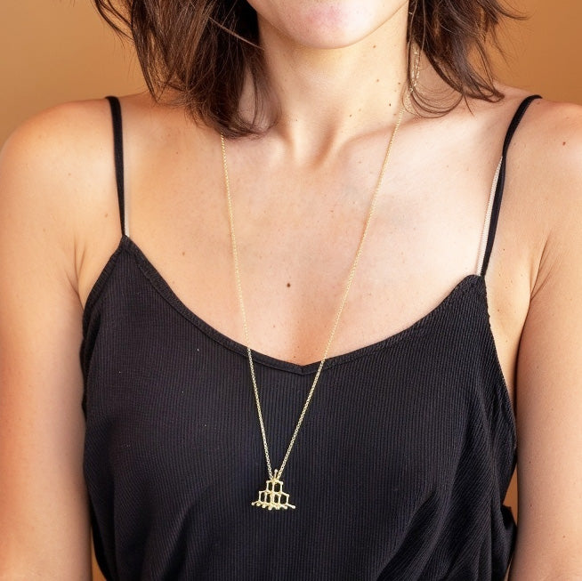 Woman wearing gold vermeil diamond crystal structure necklace, minimalist science-inspired jewelry by Science Jewelry 18:24.