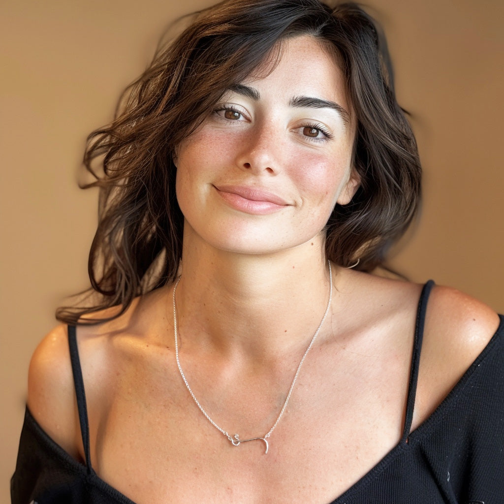 Woman wearing the Ebola virus necklace in sterling silver by Science Jewelry 18:24. The molecular-shaped pendant rests elegantly on her collarbone, blending scientific inspiration with minimalist modern design.