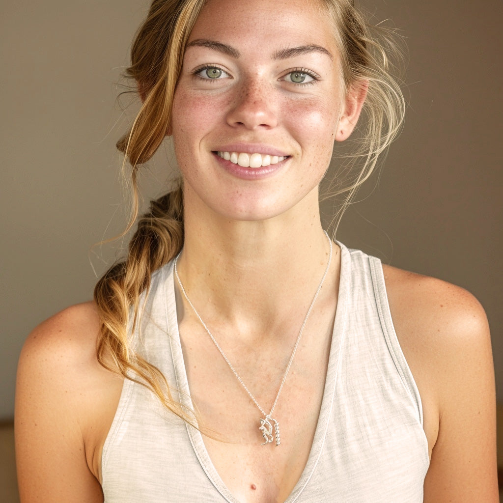 Smiling woman wearing the Exenatide Necklace on a silver chain, styled with a light tank top.