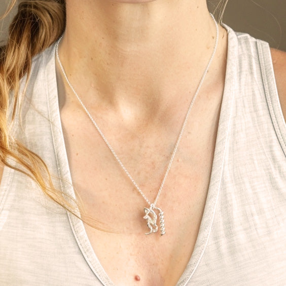 Close-up of the Exenatide Necklace in silver resting on a woman’s chest, highlighting the molecular structure pendant.