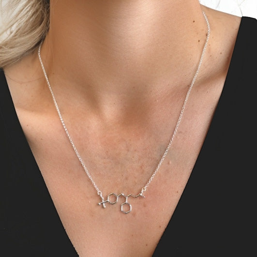 Sterling silver fluoxetine necklace on model – Prozac molecule jewelry celebrating serotonin chemistry and science-inspired elegance.