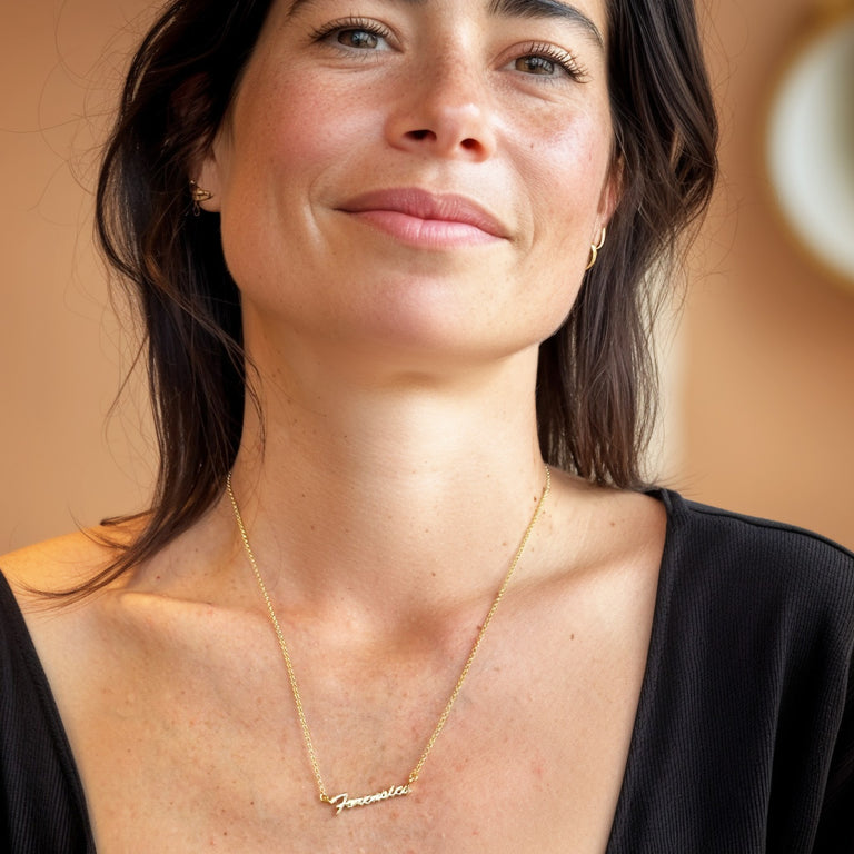 Smiling woman wearing gold vermeil forensics necklace, nerd-chic science jewelry fashion by Science Jewelry 18:24
