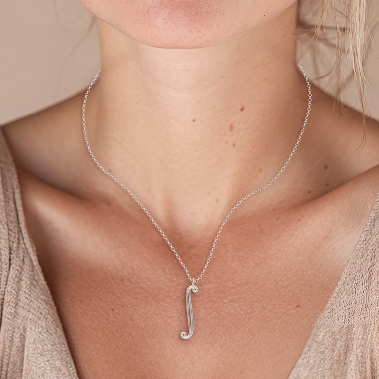 Close-up of the integral necklace worn on a woman’s neck – A delicate, math-inspired silver necklace featuring the integral symbol, ideal for mathematicians.